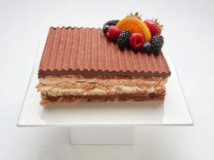 Marjolaine layered cake topped with fresh fruit in SF