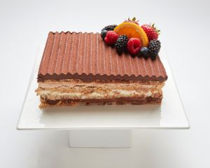 Marjolaine layered cake topped with fresh fruit in SF