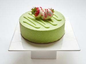 Green Matcha Tiramisu topped with white chocolate covered strawberries in SF