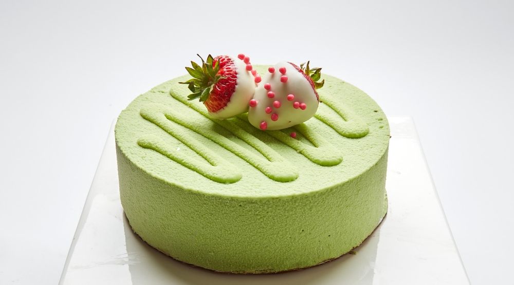 Green Matcha Tiramisu topped with white chocolate covered strawberries in SF