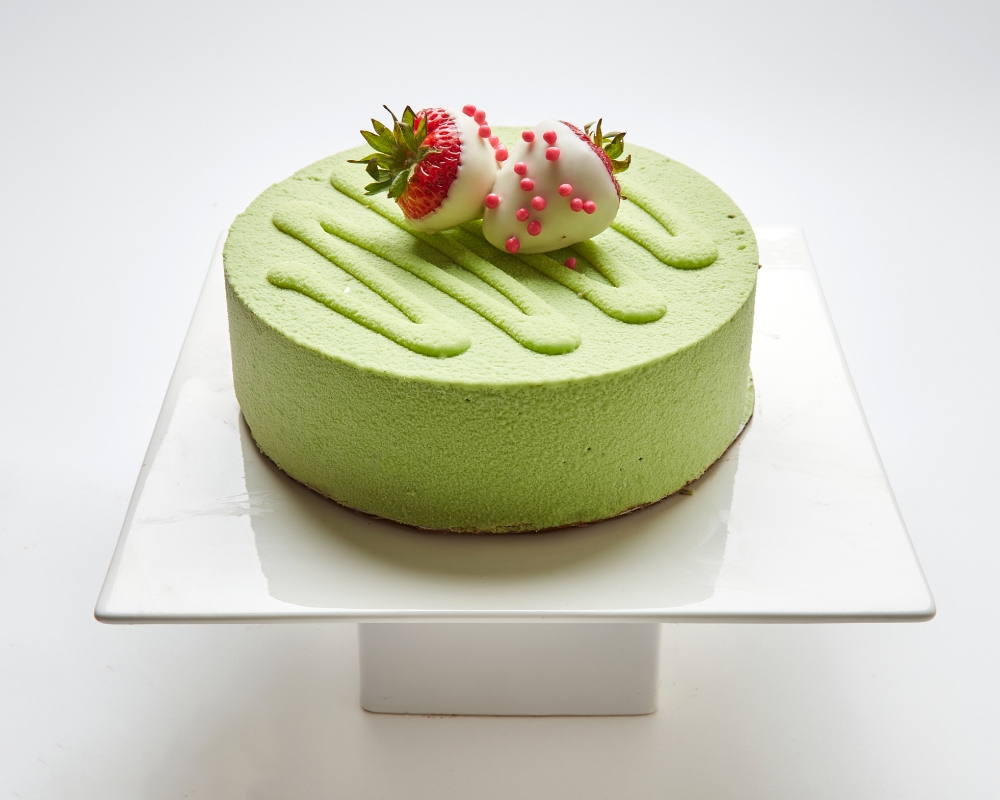 Green Matcha Tiramisu topped with white chocolate covered strawberries in SF