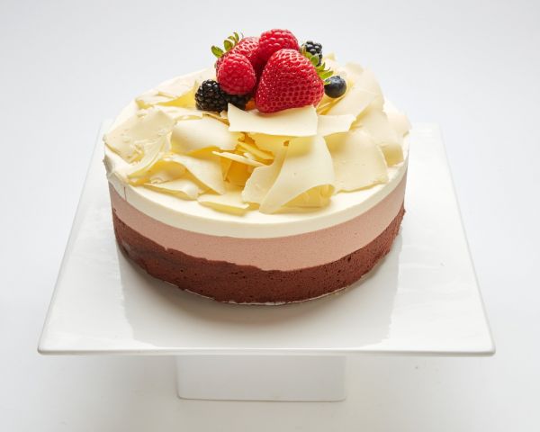 Triple Chocolate Mousse cake topped with white chocolate and fruit in SF